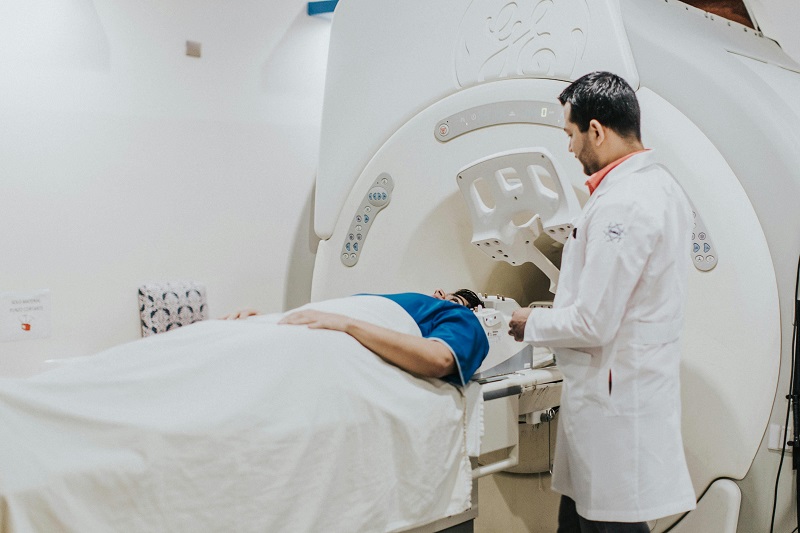 doctor using an advanced diagnostic machine with a patient