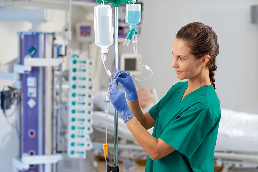 An infusion pump connected to an IV stand administers fluids to a patient an Essential medical equipment