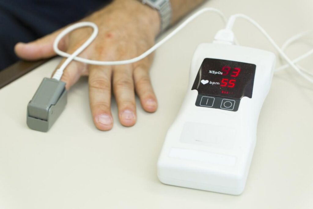 pulse oximeter in use, checking oxygen levels an Enssential medical devices at home