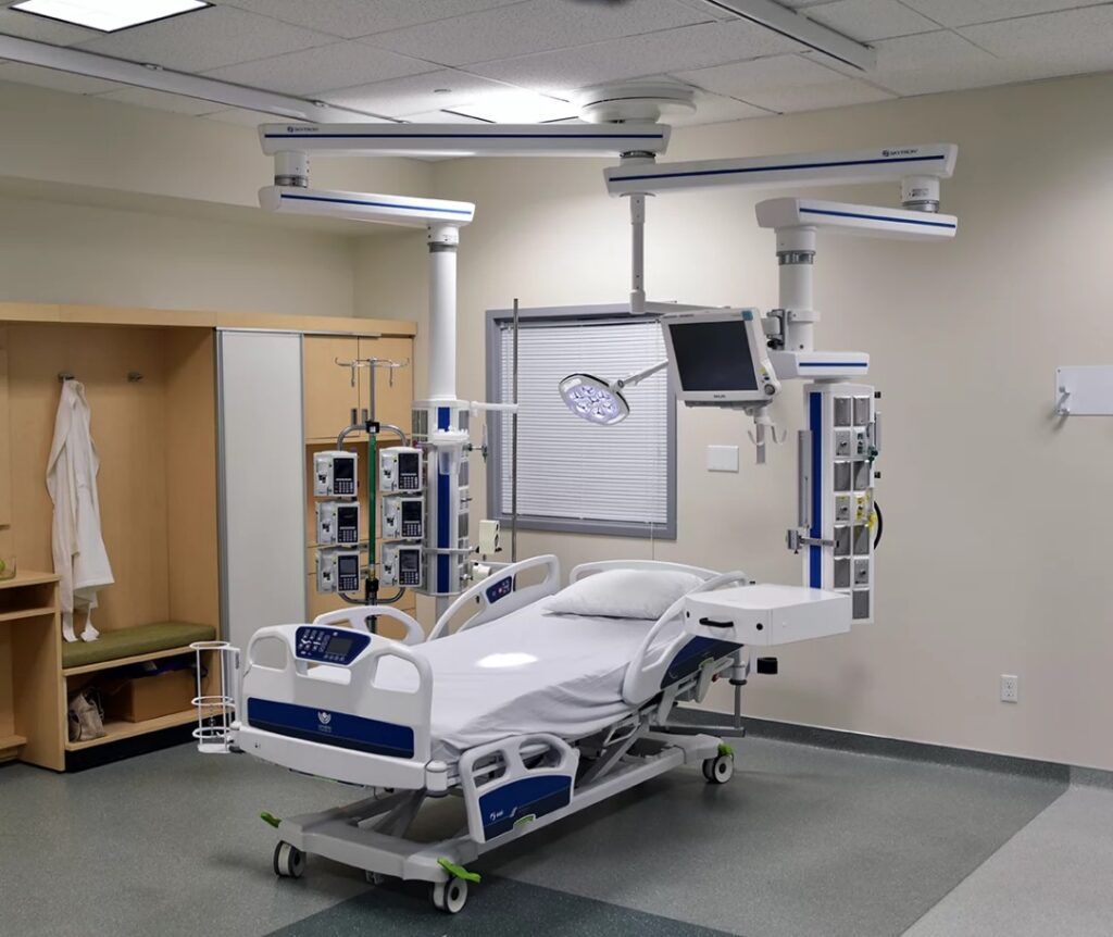 well-lit examination room featuring an adjustable examination table and overhead examination light.