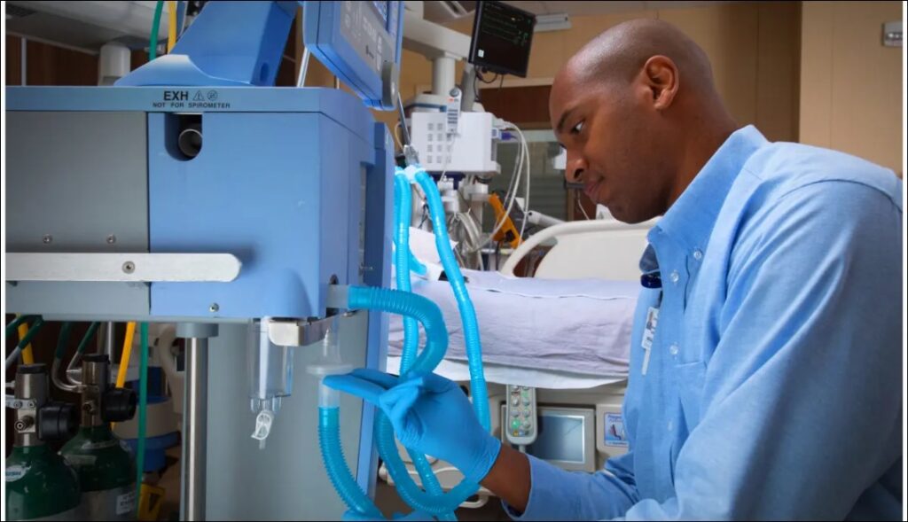 healthcare worker inspecting medical equipment