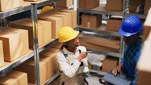 A Nigerian entrepreneur inspecting medical equipment in a store or warehouse