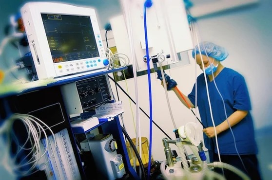 A healthcare worker setting up newly delivered equipment for a medical supply business