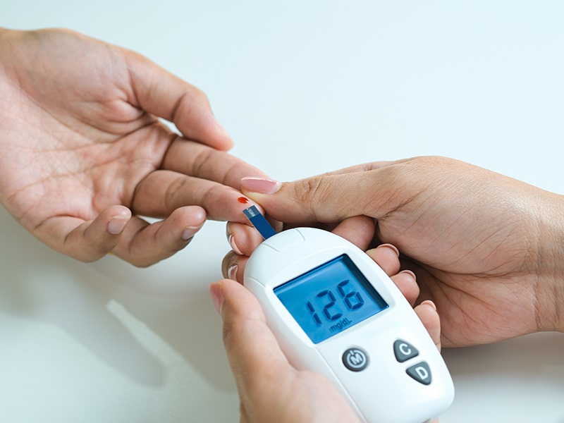 Glucometer displaying patient blood sugar reading.