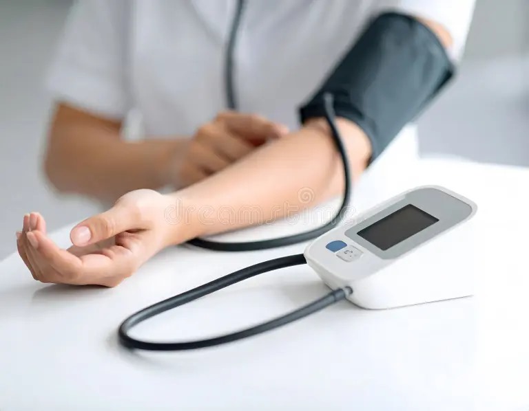 Nurse conducting BP check using a digital monitor