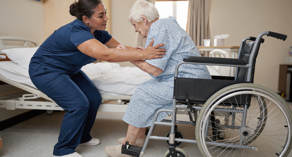 Caregiver helping an elderly patient transfer safely into a wheelchair. best wheelchairs to buy in Nigeria